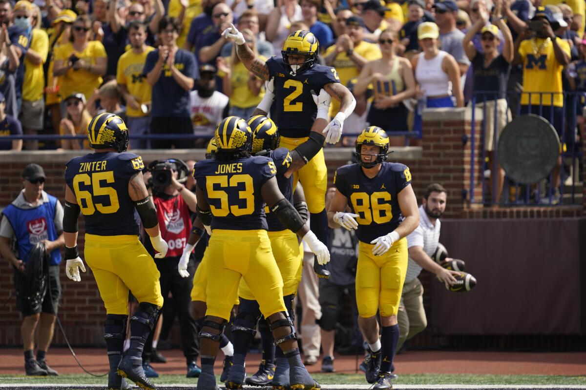 Corum scores 5 TDs No. 4 Michigan routs Connecticut 59 0 The